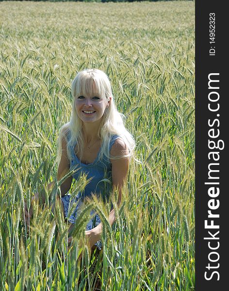 Blond woman in field of wheat