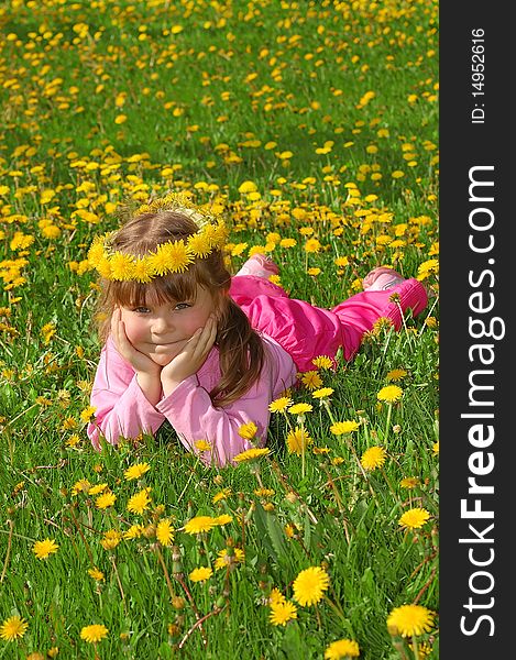 Girl In A Wreath From Dandelions On A Grass