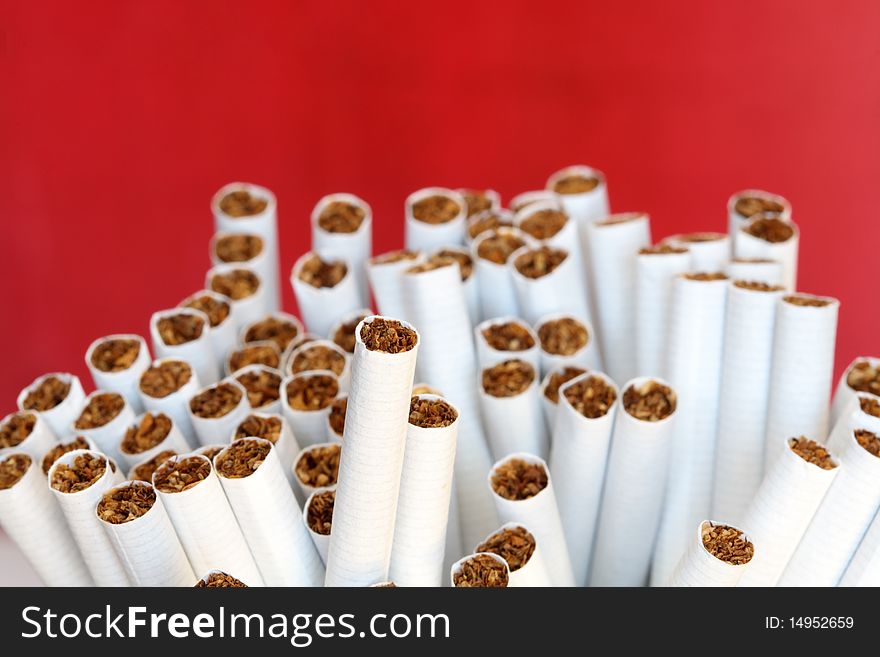 A lot of cigarettes on red background