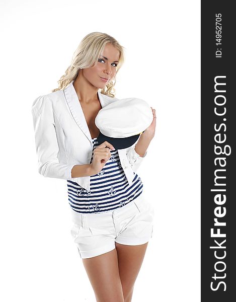 A young and cute girl in a white coat is holding a sailor hat. The image is isolated on a white background. A young and cute girl in a white coat is holding a sailor hat. The image is isolated on a white background.