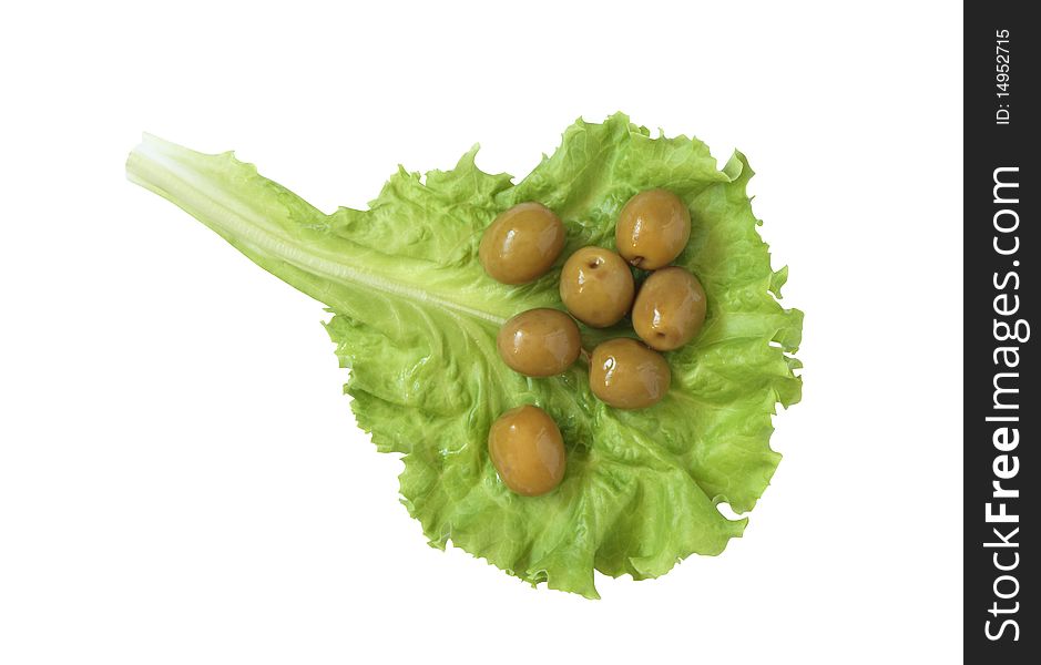 Few green olives lying on lettuce leaf. Isolated on white with clipping path. Few green olives lying on lettuce leaf. Isolated on white with clipping path