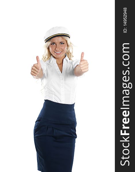 A young and attractive girl in a sailor hat is holding thumbs up as a sign of success. The image is isolated on a white background. A young and attractive girl in a sailor hat is holding thumbs up as a sign of success. The image is isolated on a white background.