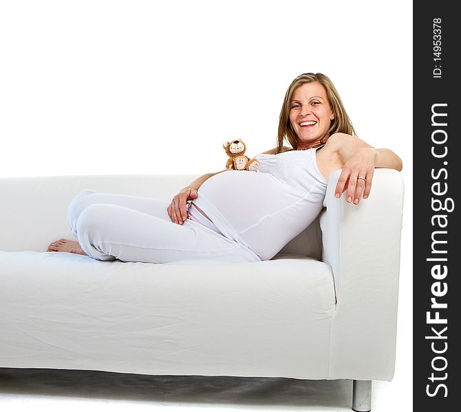 Young fresh pregnant woman with baby toys. Isolated over white background. Young fresh pregnant woman with baby toys. Isolated over white background.