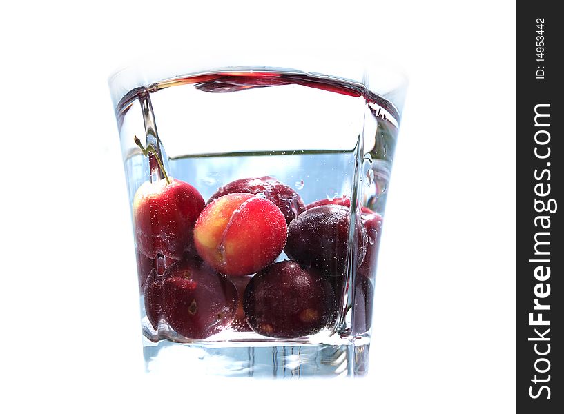 Ripe juicy cherries in glass with pure fresh water. Ripe juicy cherries in glass with pure fresh water