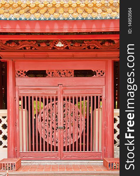 Chinese style wooden red door as cage, Ayutthaya Thailand.