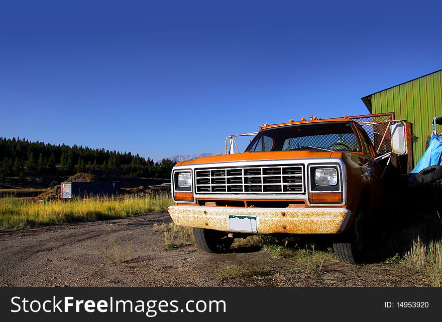 Abandoned old rustic truck with blue sky background