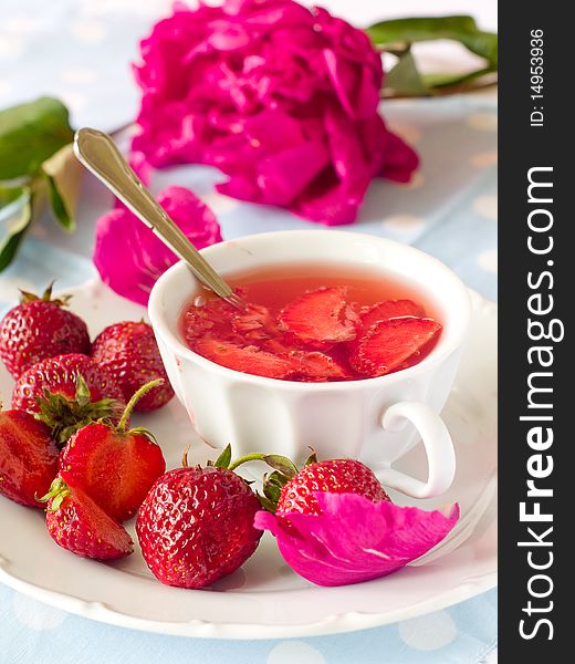 Strawberry tea in a white mug with fresh strawberry. Strawberry tea in a white mug with fresh strawberry