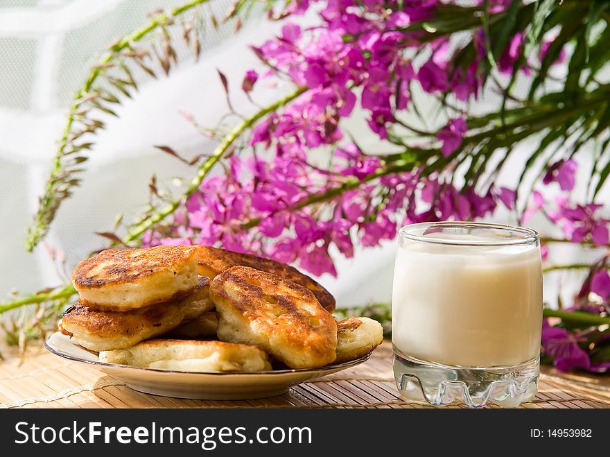 Breakfast in summer day in village: pancakes with milk