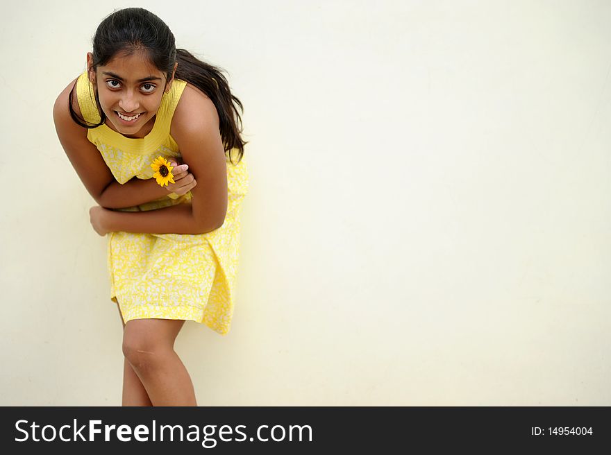 Indian beautiful girl posing at outdoor yellow wall. Indian beautiful girl posing at outdoor yellow wall