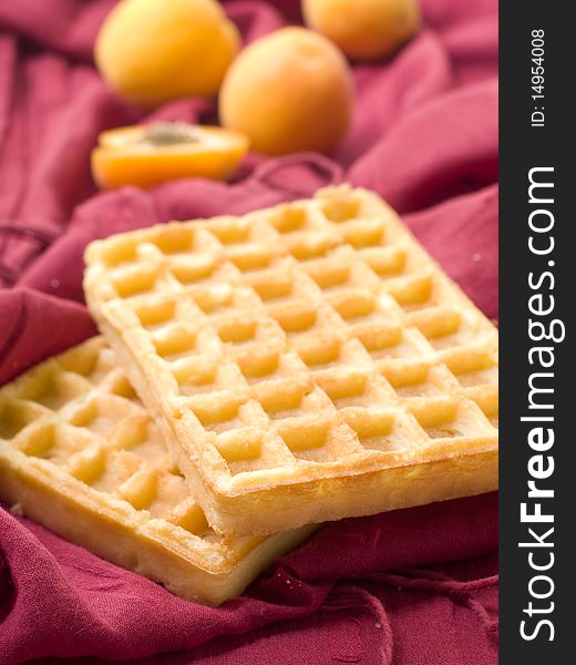 Two fresh wafers on a claret background