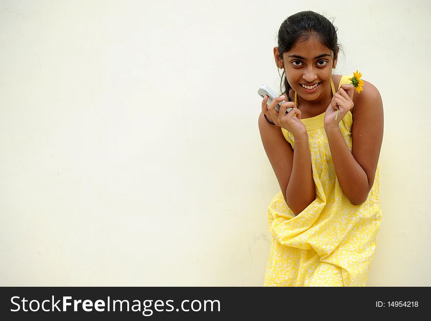 Indian beautiful girl posing at outdoor yellow wall. Indian beautiful girl posing at outdoor yellow wall