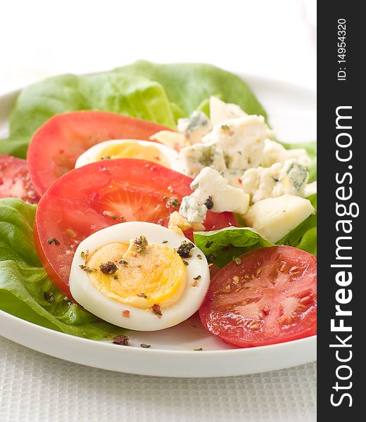 Salad from lettuce, tomatoes, eggs  and cheese. Salad from lettuce, tomatoes, eggs  and cheese