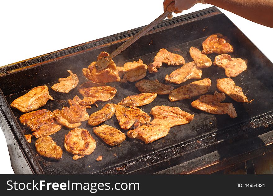 Male hand preparing roasting chicken slices isolated on white background. Male hand preparing roasting chicken slices isolated on white background