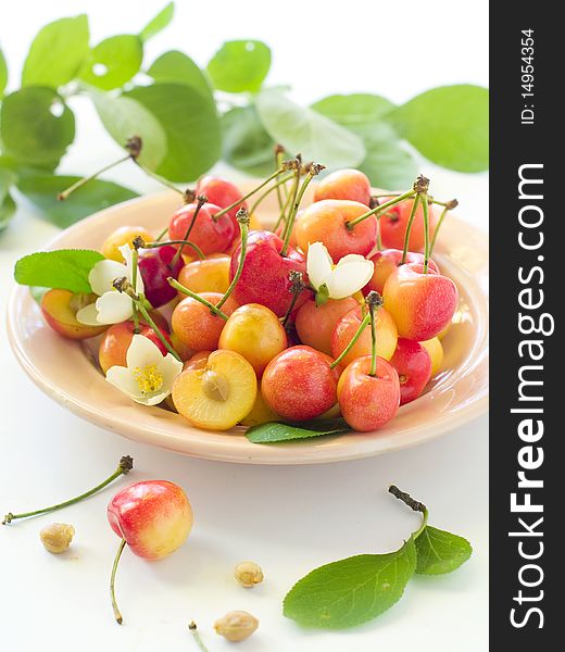 A cup of cherry with flower on light background