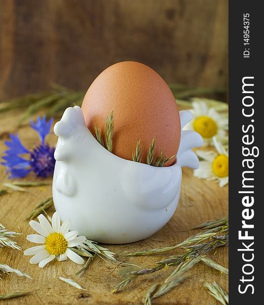 Egg in white chicken ceramic eggcup. Egg in white chicken ceramic eggcup