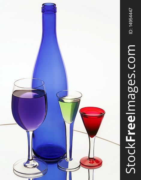 Dark blue bottle and three wine glasses