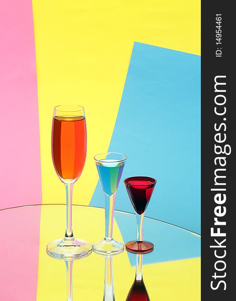 Three Wine-glasses On Multi-coloured Background