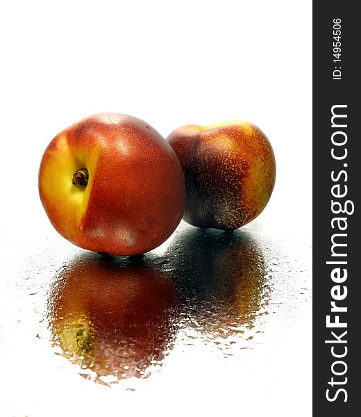 Nectarine on the white background with water drops