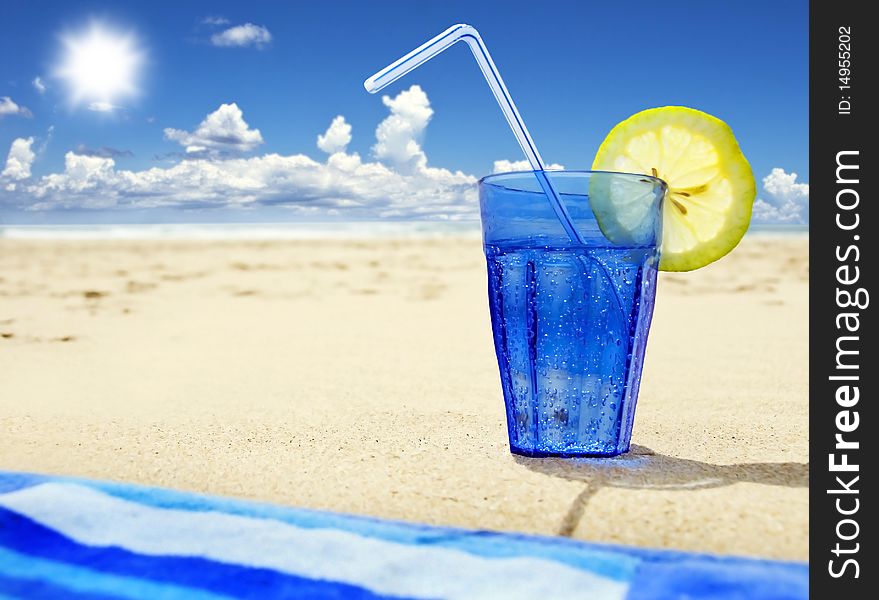 A Glass of sparkling water on a tropical island beach. A Glass of sparkling water on a tropical island beach