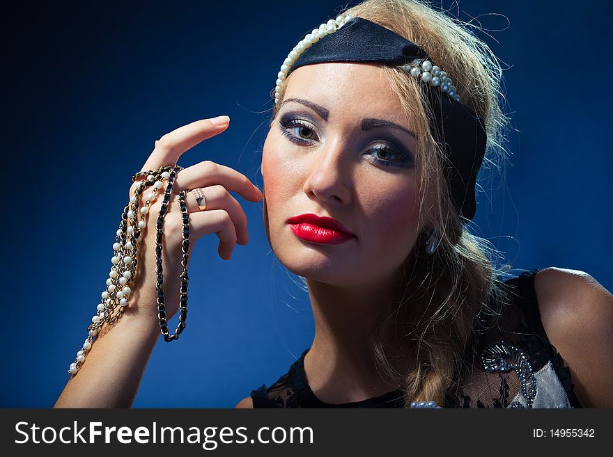 Portrait of attractive retro-style girl in bonnet over black