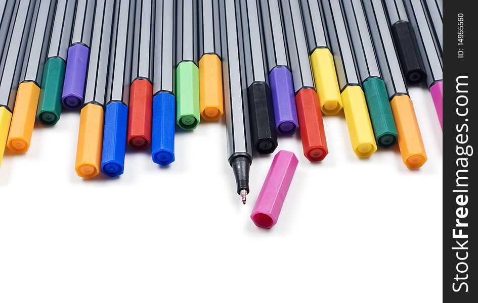 Colourful pens on a white background with space for text