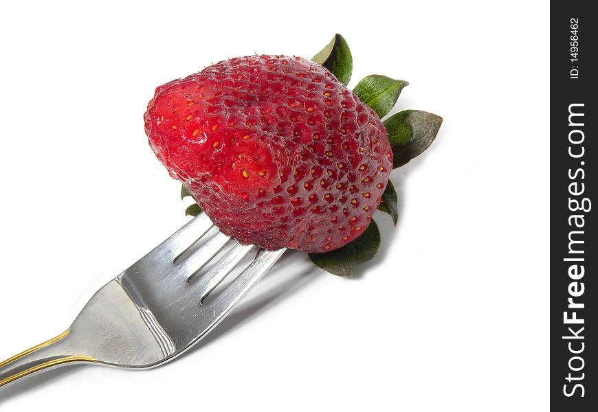 Strawberry with a fork .Eating strawberry
