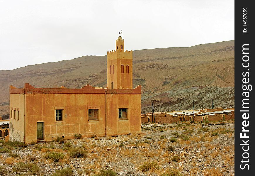 Small remote desert mosque near a village by the mountains