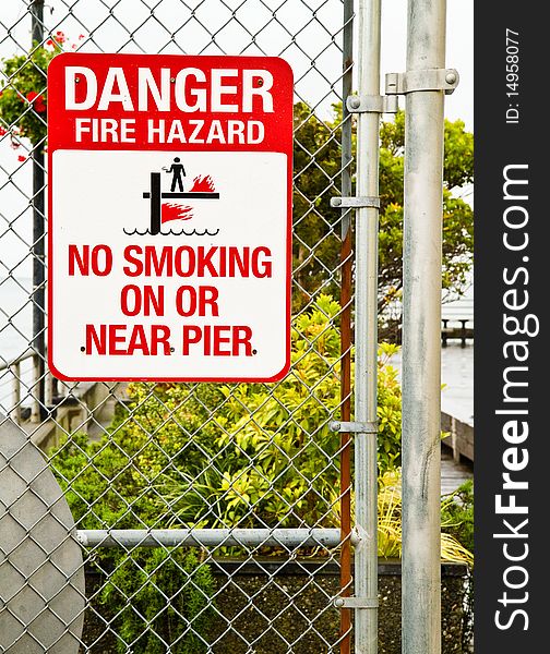 Fire Hazard sign warning people not to smoke on or near the pier. Fire Hazard sign warning people not to smoke on or near the pier