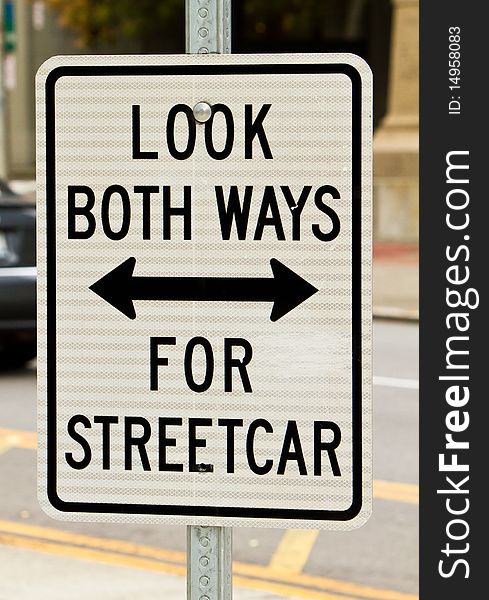 Sign warning pedestrians to look out for the streetcar. Sign warning pedestrians to look out for the streetcar