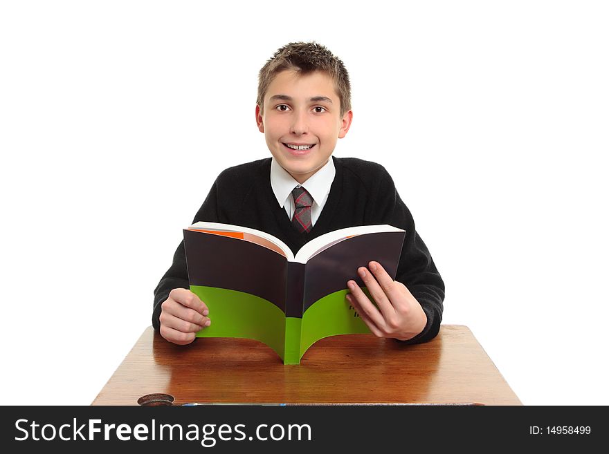 Happy smiling high school student sitting at a desk with a textbook.  White background. Happy smiling high school student sitting at a desk with a textbook.  White background.