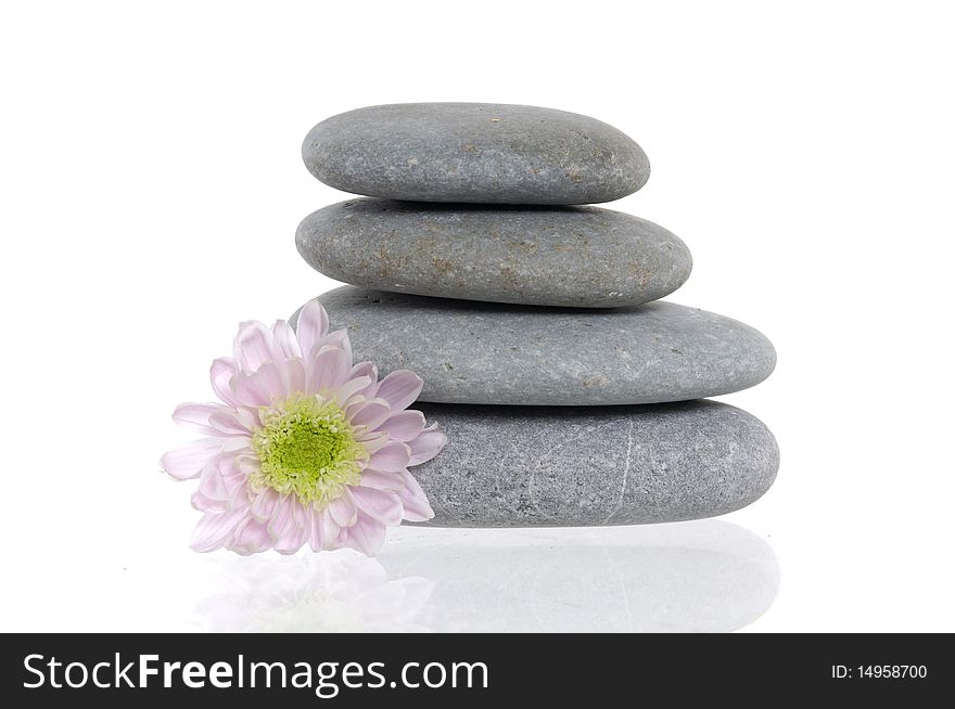 Flower and stack of spa pebbles with reflection. Flower and stack of spa pebbles with reflection