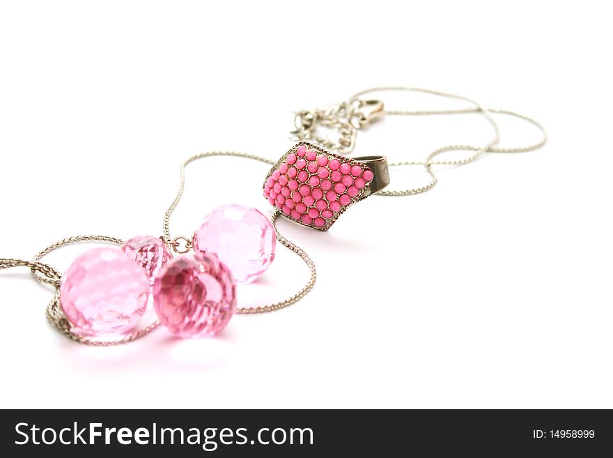 Ring and necklace with pink stones isolated on white background.