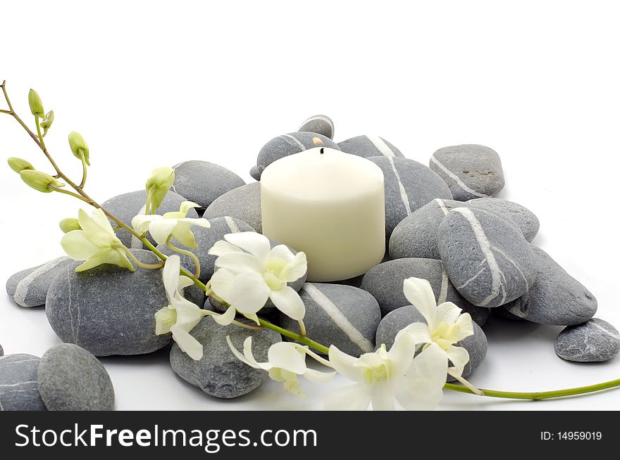 Spa setting with beautiful white flowers, pebbles and candle. Spa setting with beautiful white flowers, pebbles and candle.