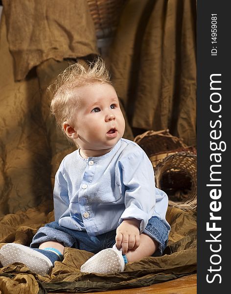 Close up of smiling baby sitting on a floor. Close up of smiling baby sitting on a floor