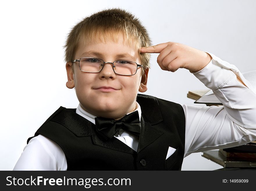 Funny school boy thinking. Isolated over white