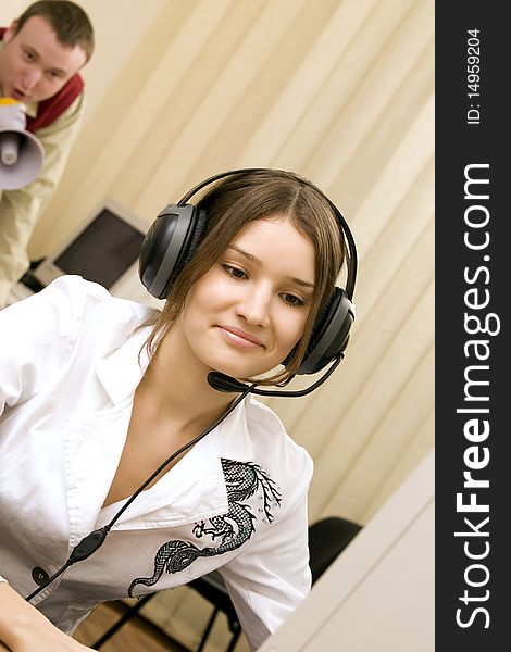 Woman with headset at workplace and her boss