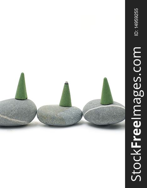 Green Incense cones on gray stones. Green Incense cones on gray stones