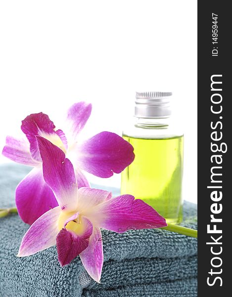 bottles of essential oil with .orchid on blue towel. bottles of essential oil with .orchid on blue towel