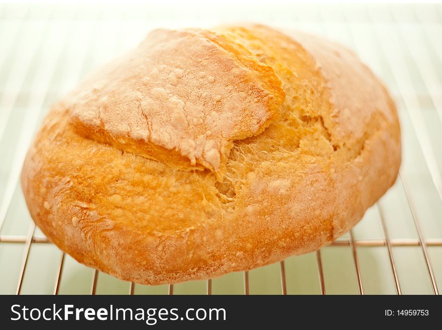 A freshly baked, warm loaf of bread. A freshly baked, warm loaf of bread.