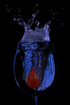 Strawberry Splash In A Glass Of Blue Water Stock Images Strawberry Splash In A Glass Of Blue Water Stock Images