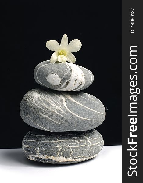 Beautiful orchid laying on stack zen stone. Beautiful orchid laying on stack zen stone