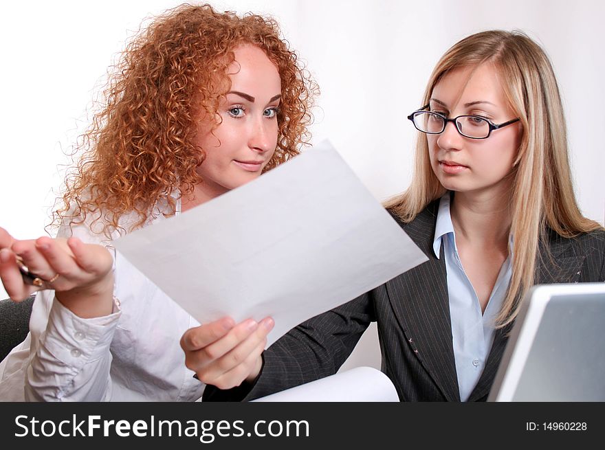 Young smiling business woman working and consulting a partner. Young smiling business woman working and consulting a partner