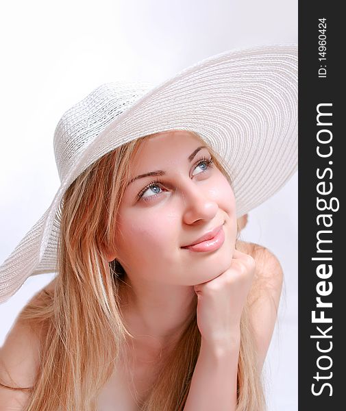 Summer blond girl wearing a white hat