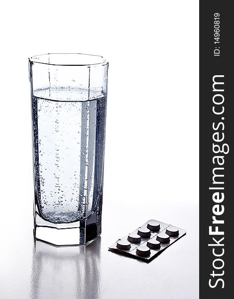 Glass of soda and pill on white background. Glass of soda and pill on white background