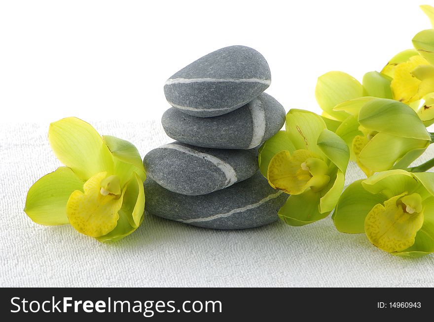 Spa essentials pyramid of stones with orchid. Spa essentials pyramid of stones with orchid