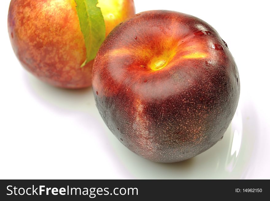 Ripe tasty peach on white background