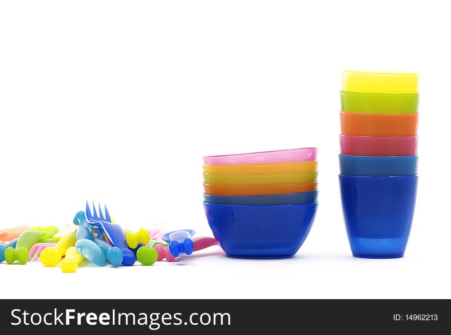 Stack of color plastic dishes, knife ,fork, spoon. Stack of color plastic dishes, knife ,fork, spoon