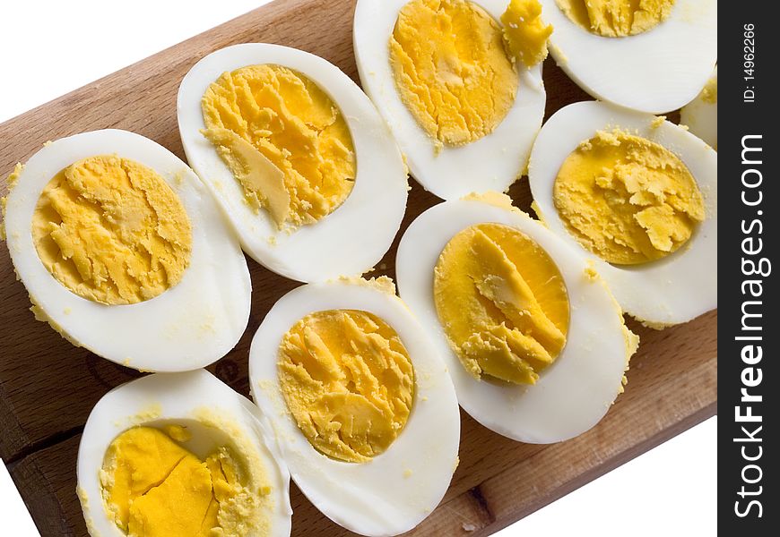 Boiled, cut eggs on the wooden board