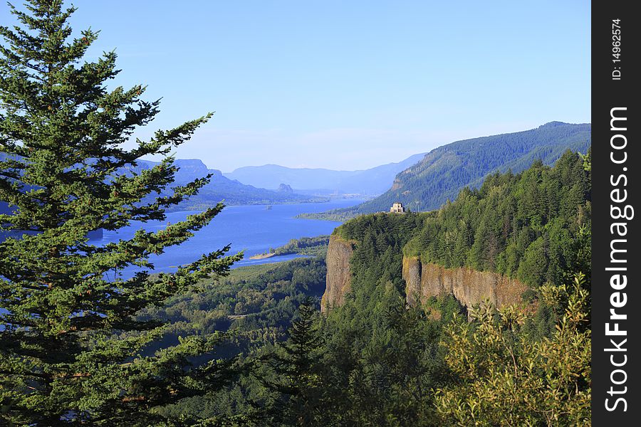 A view of the Columbia river gorge valley and vista house in the distance. A view of the Columbia river gorge valley and vista house in the distance.