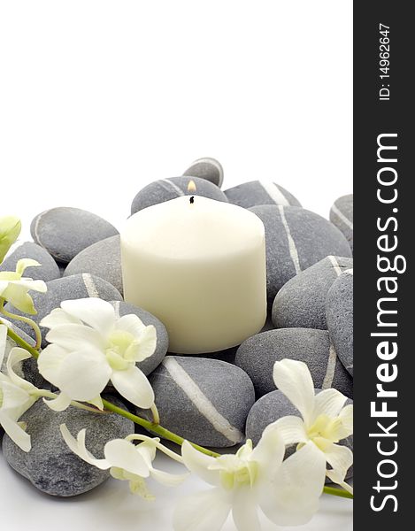 Spa setting- white flowers, pebbles and candle. Spa setting- white flowers, pebbles and candle